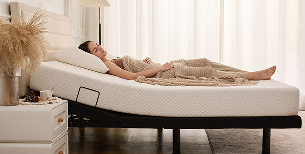 woman laying on a mattress on an adjustable base