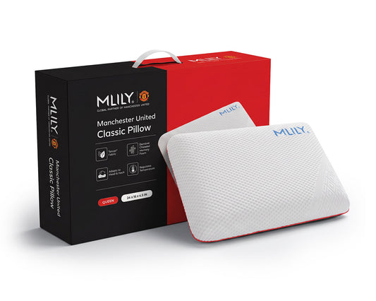 MLILY Manchester United Classic Pillow with a white textured cover and red trim, displayed beside its black and red retail packaging.