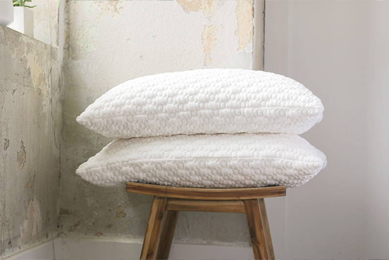 Stack of two pillows sitting on a stool